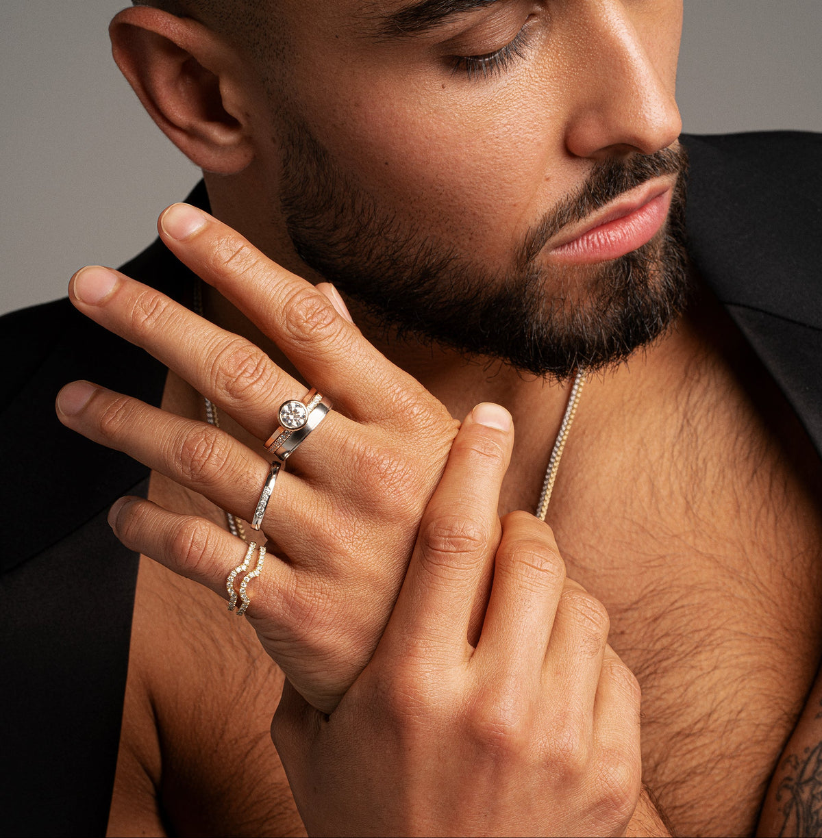 Man wearing multiple rings, from the Synergi Collection, handcrafted in the UK - Avila Vara